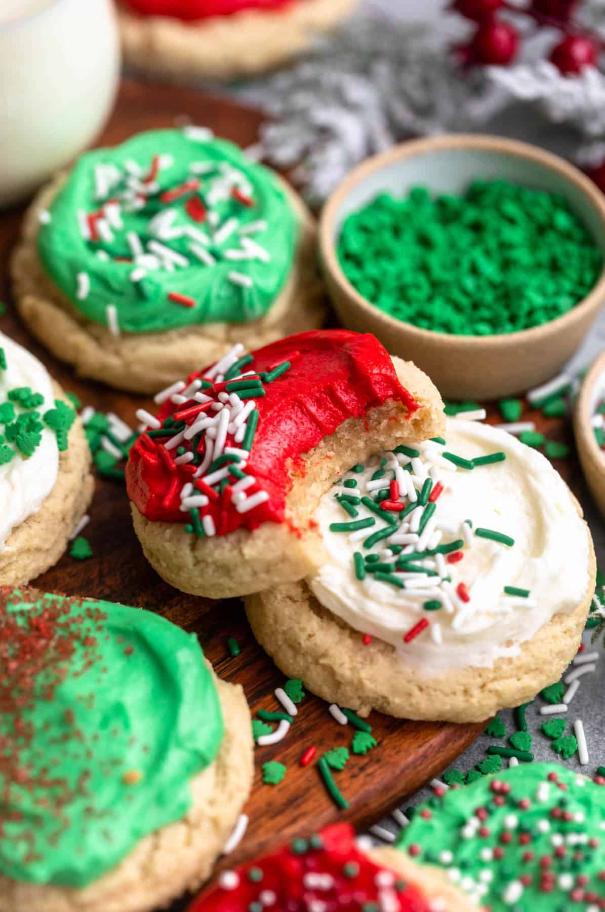 gluten free christmas cookies with frosting on a wood board