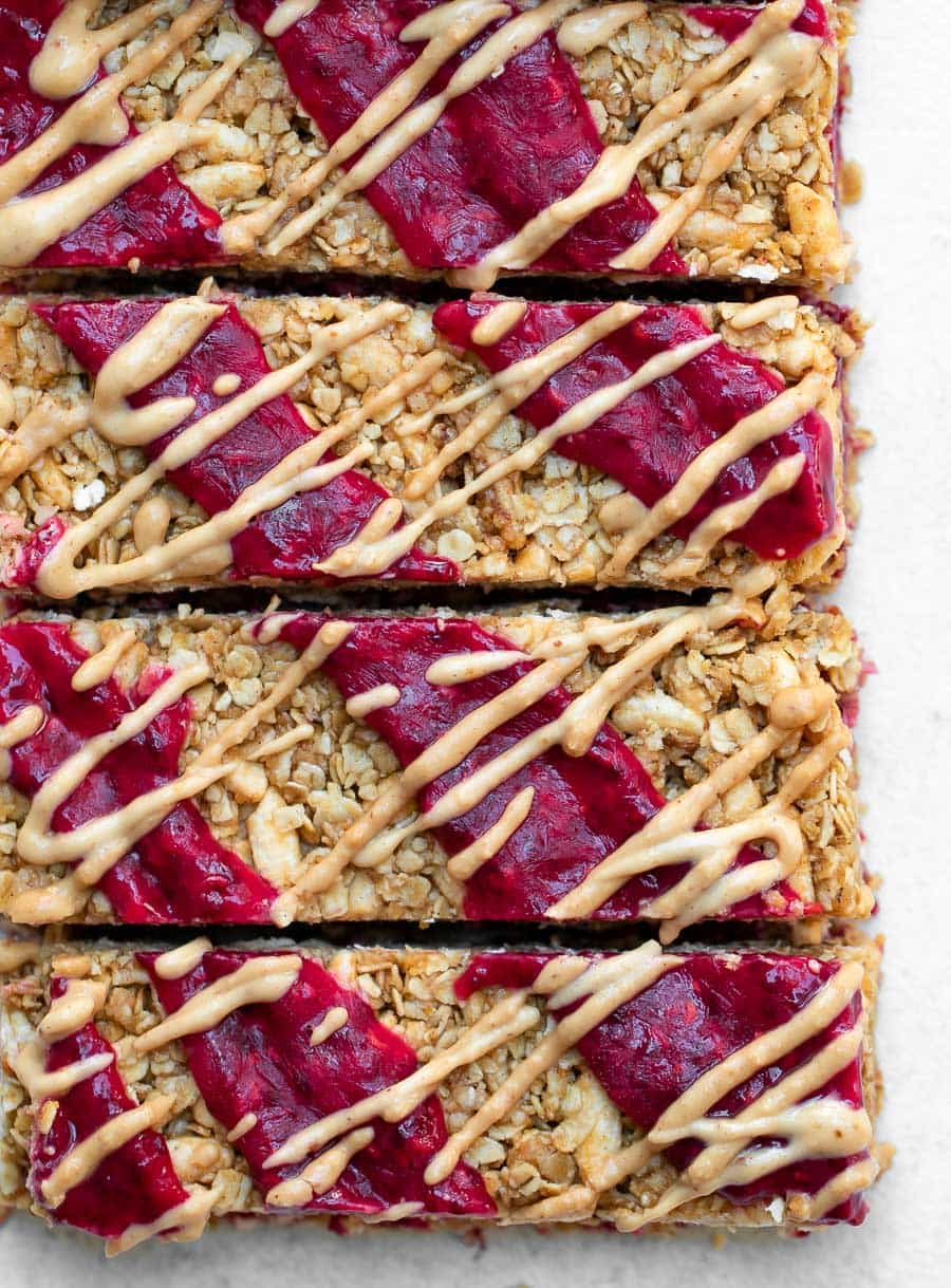 4 no bake granola bars with peanut butter and jam on top.
