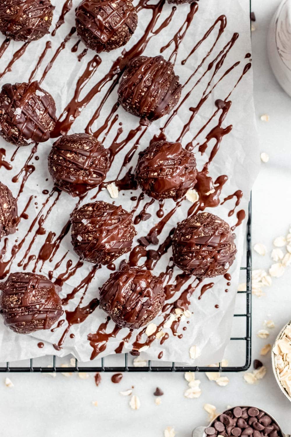 Chocolate bliss balls drizzled with chocolate sauce.