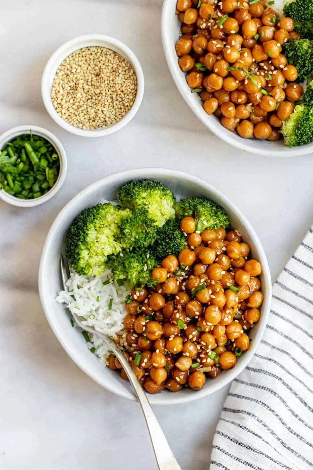 Sticky sesame chickpea recipe with rice and broccoli in a small bowl.