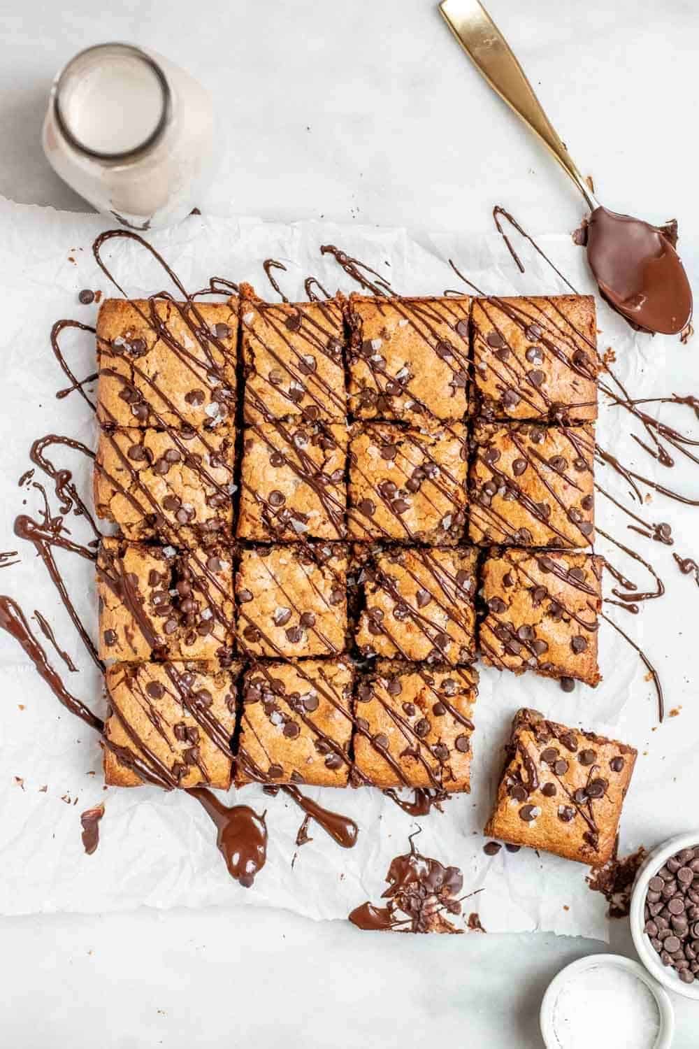 Gluten free blondies with chocolate drizzled on top.