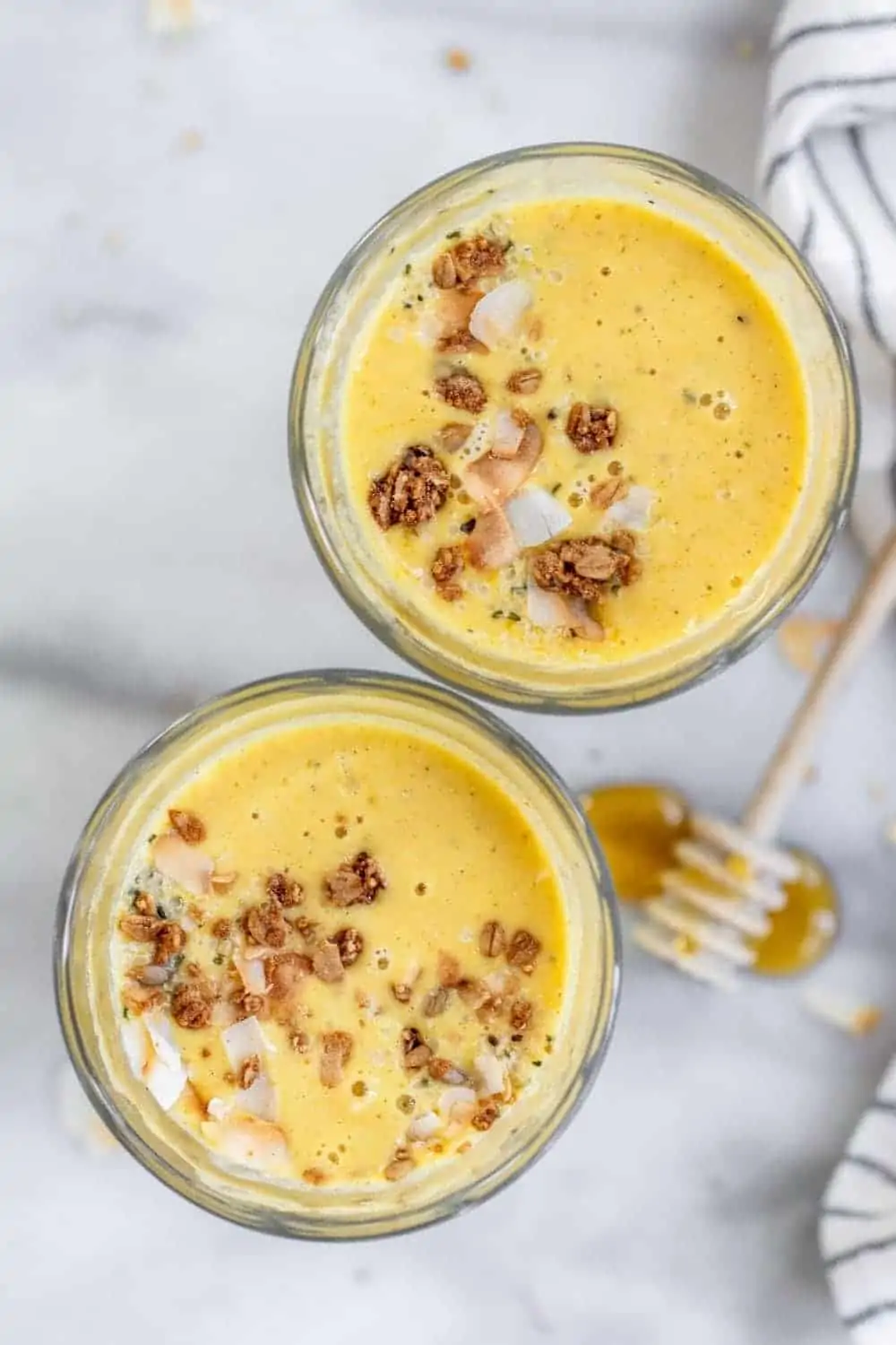 Overhead shot of turmeric smoothie with granola on top.