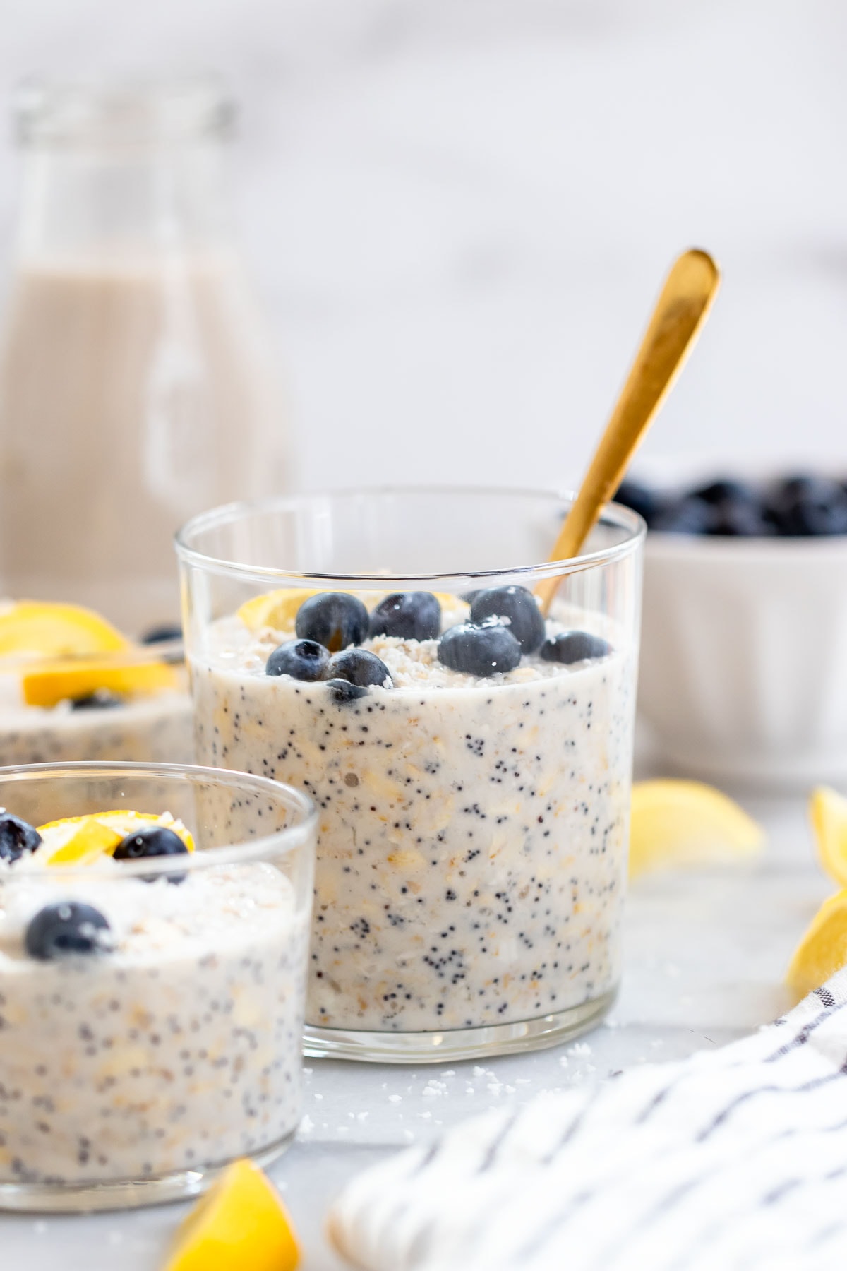 Overnight oats with blueberries in a small glass cup.