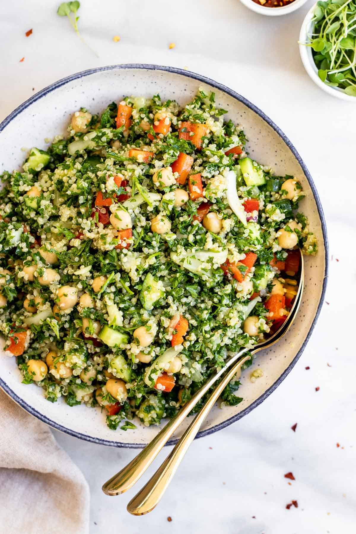 Overhead shot of the quinoa tabbouleh salad recipe with fresh parsley in a blue bowl. 