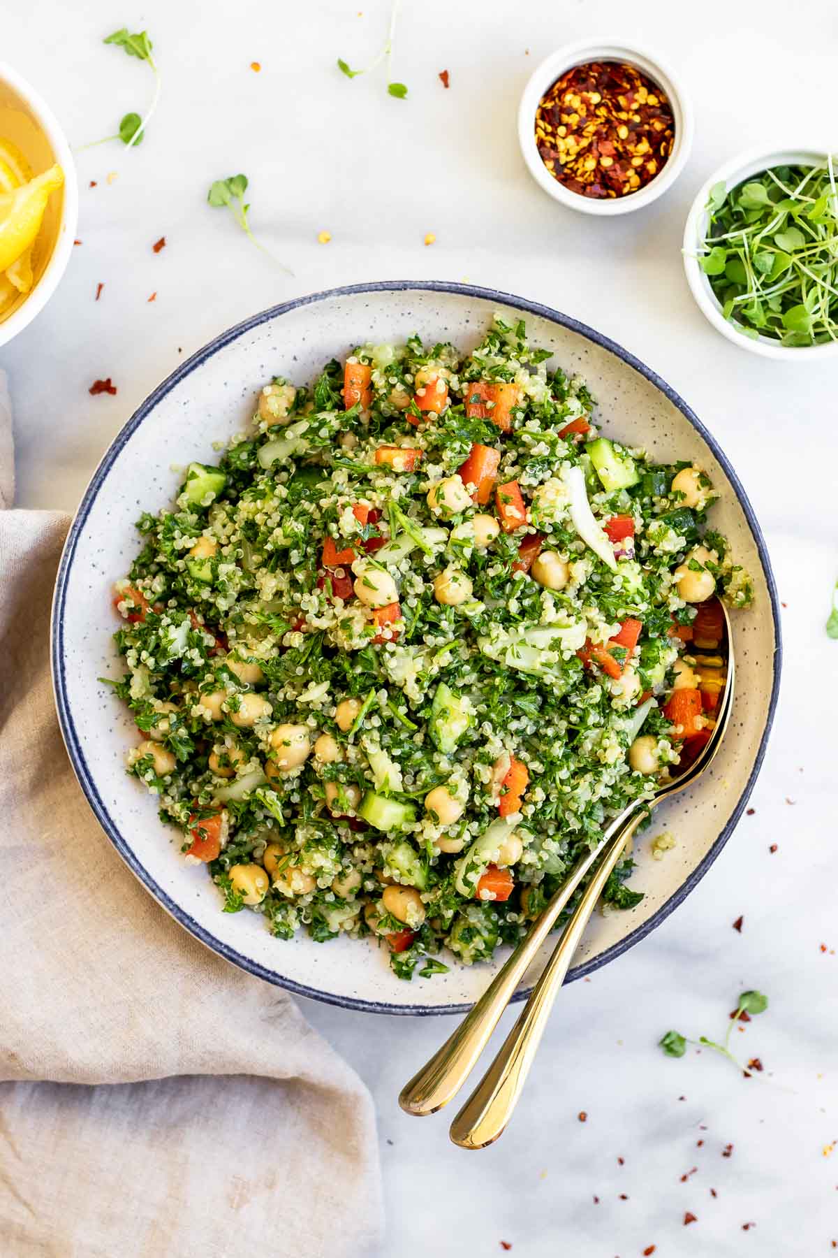 Gluten free quinoa tabbouleh salad in a large blue bowl.