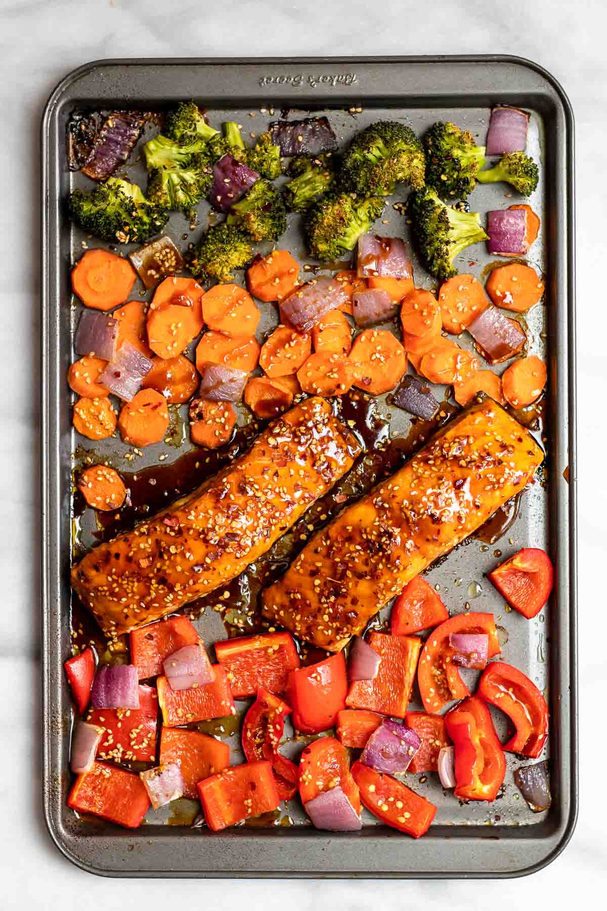 Sheet pan salmon with roasted peppers, broccoli and carrots.