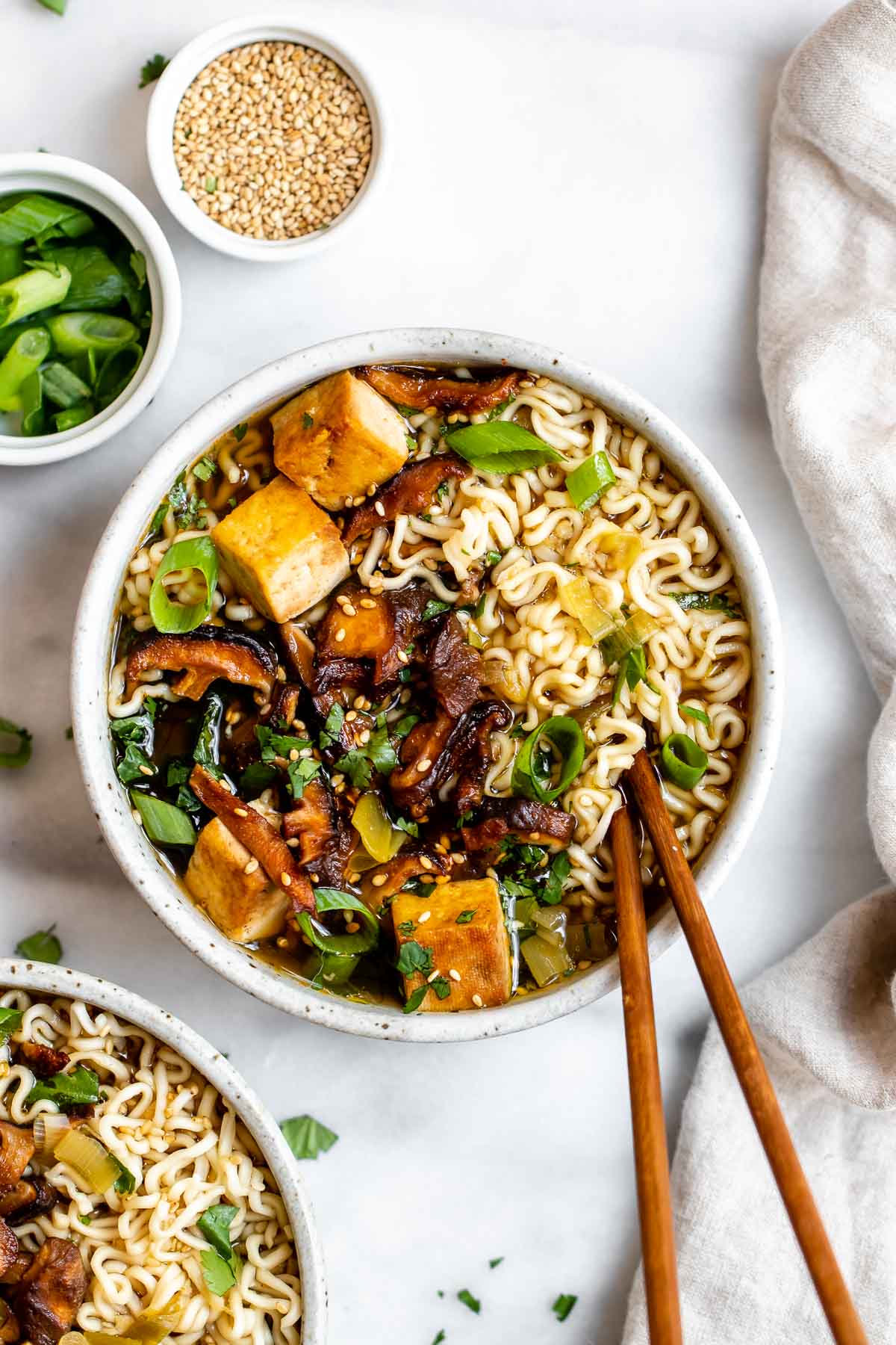 Vegan ramen noodles with mushrooms and tofu in a small bowl.