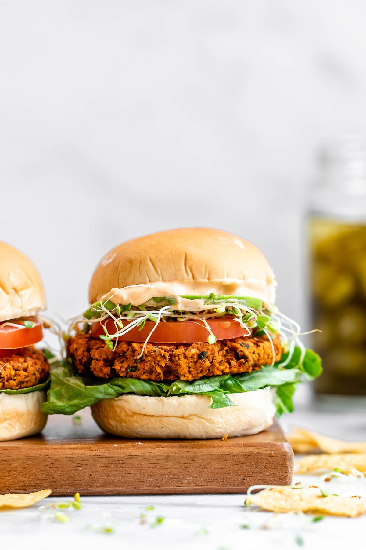 Chickpea burger with lettuce, tomato and tahini dressing.