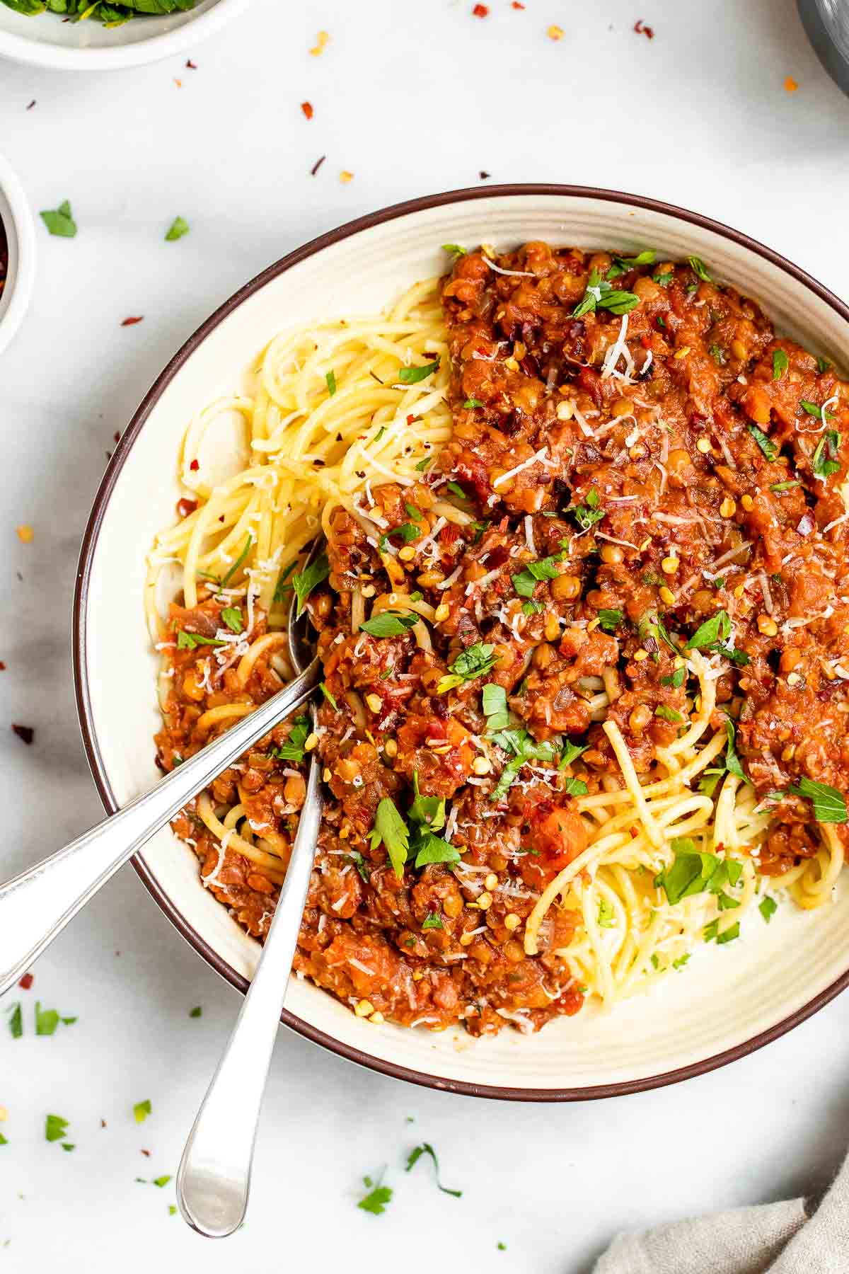 vegan lentil bolognese with two spoons on the side