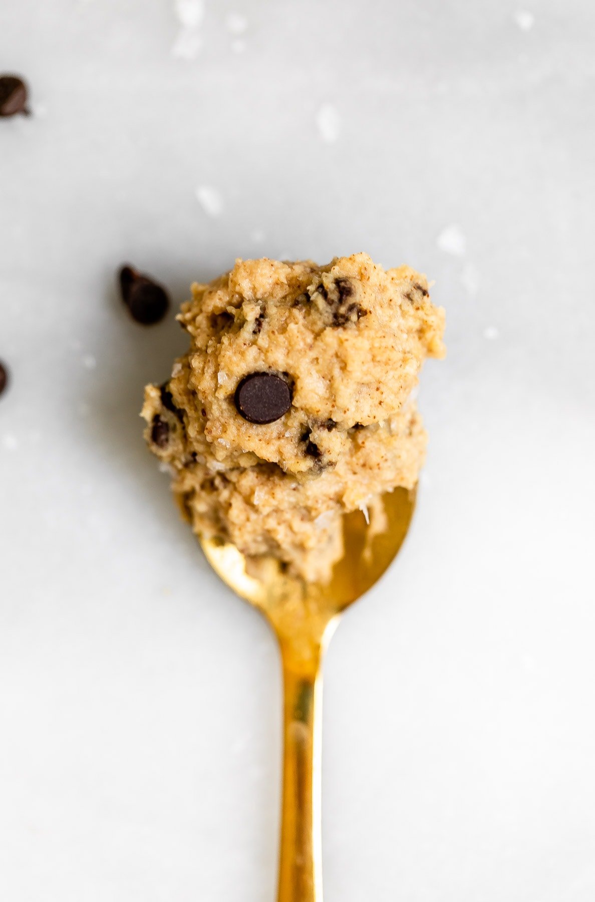 Gold spoon with the chickpea cookie dough on top.