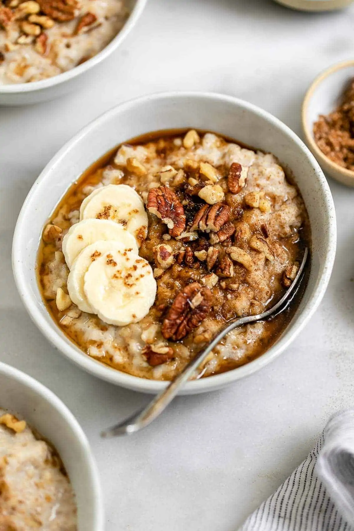 Brown sugar oatmeal in a bowl with a spoon on the side.