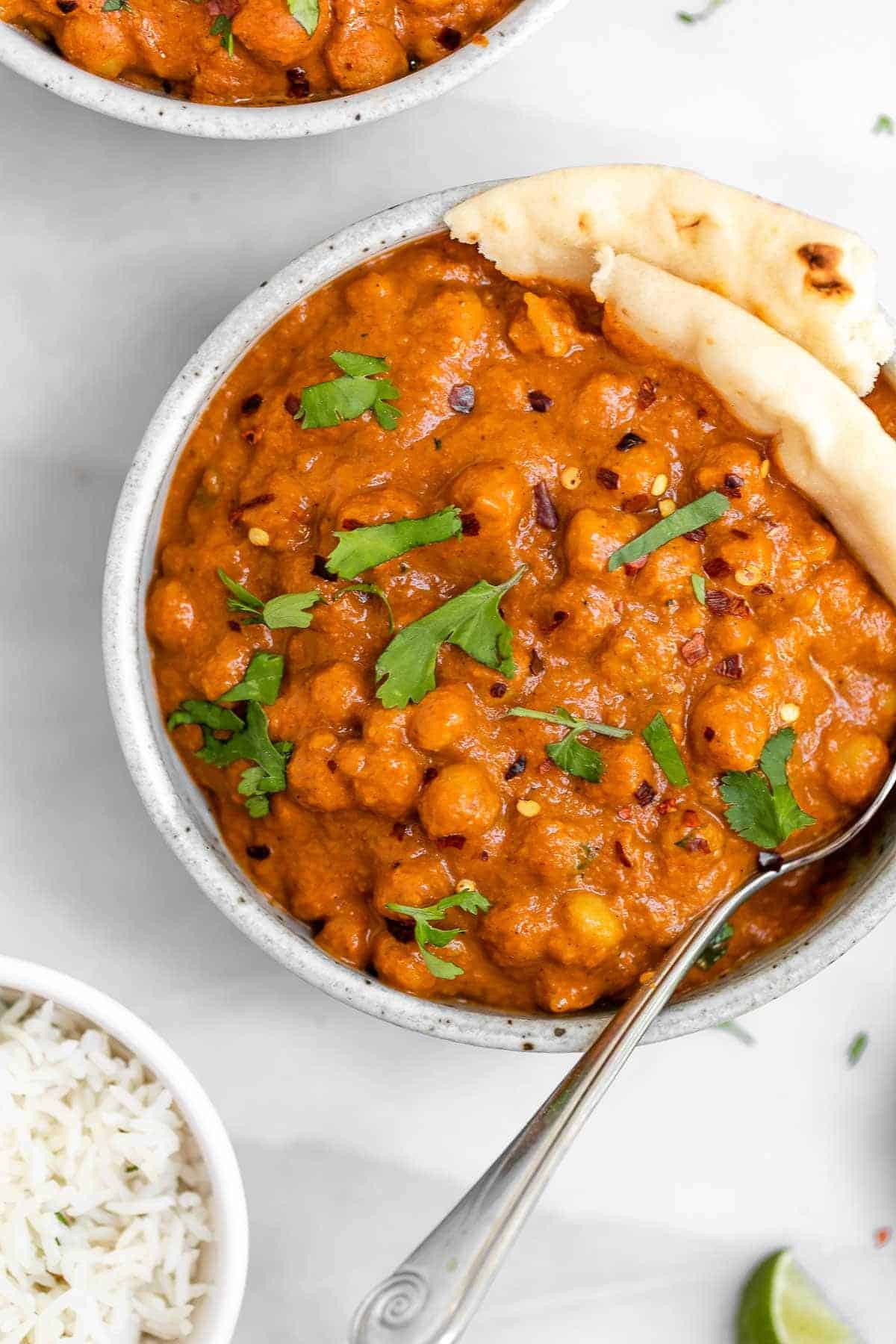 Close up image of the vegan chickpea tikka masala in a round bowl.