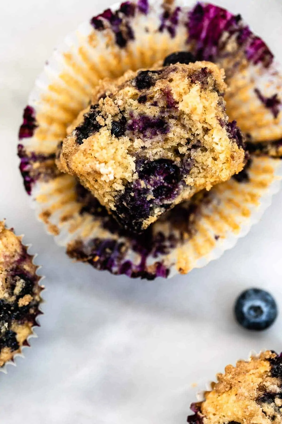 Up close image of the almond flour blueberry muffin with a bite taken out.