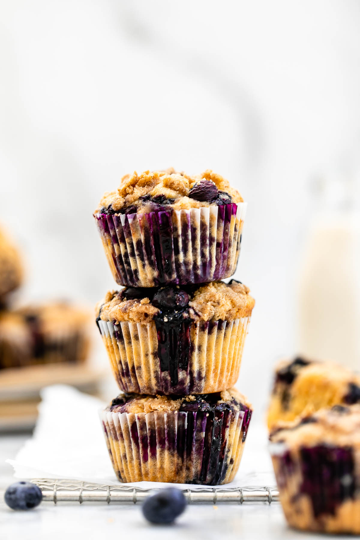 Three almond flour blueberry muffins stacked on each other.