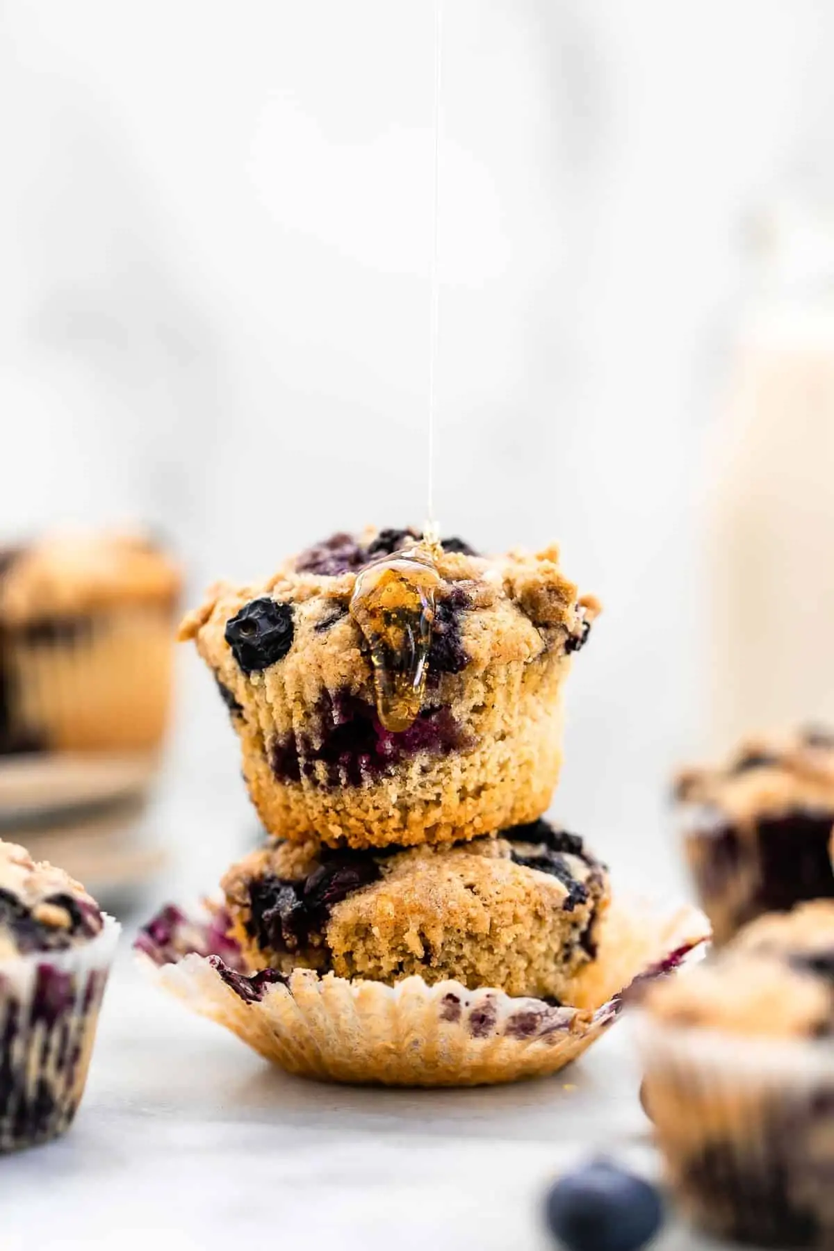 Honey dripping down a blueberry muffin. 