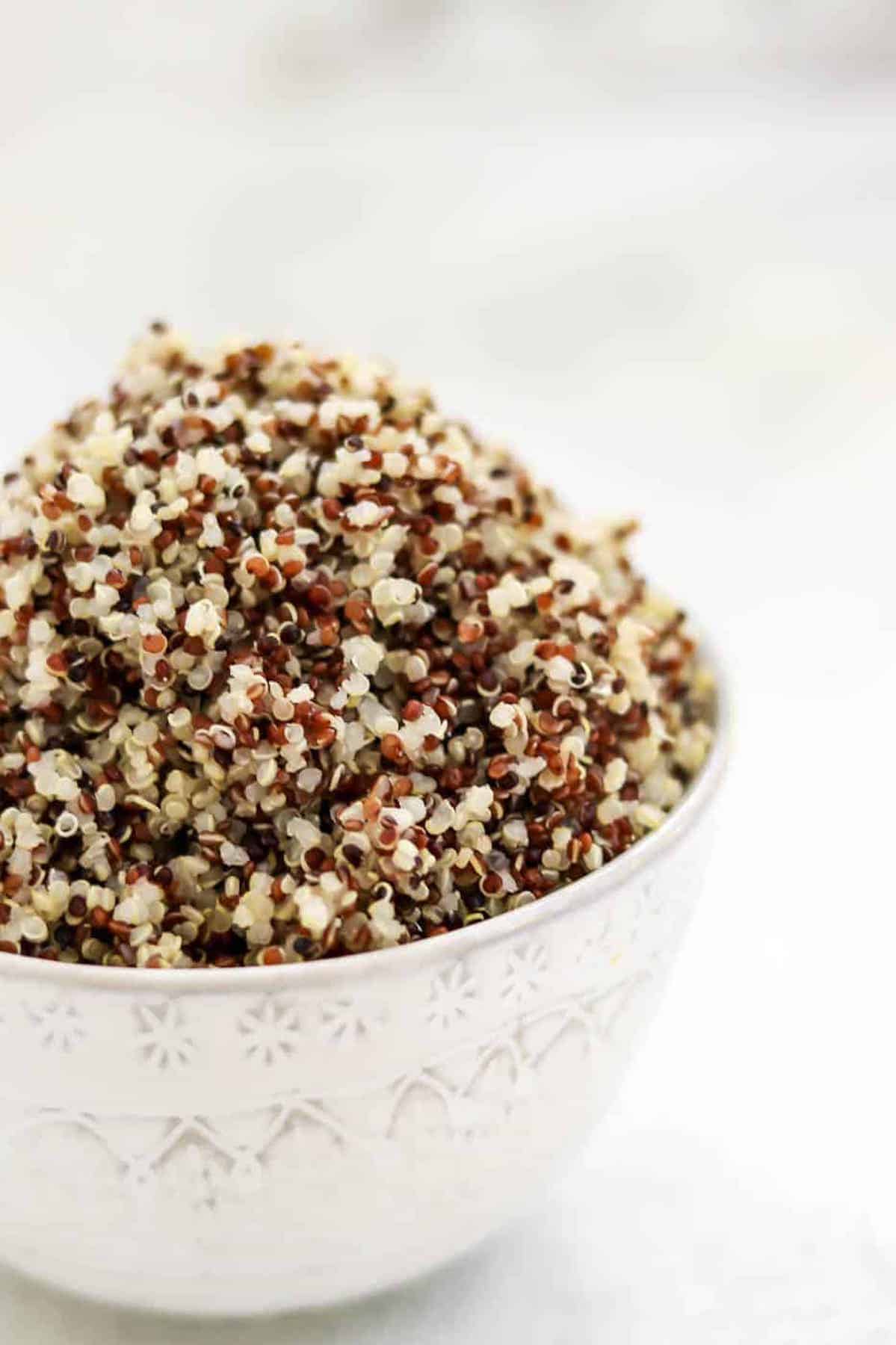 Tri-color quinoa in a white bowl. 