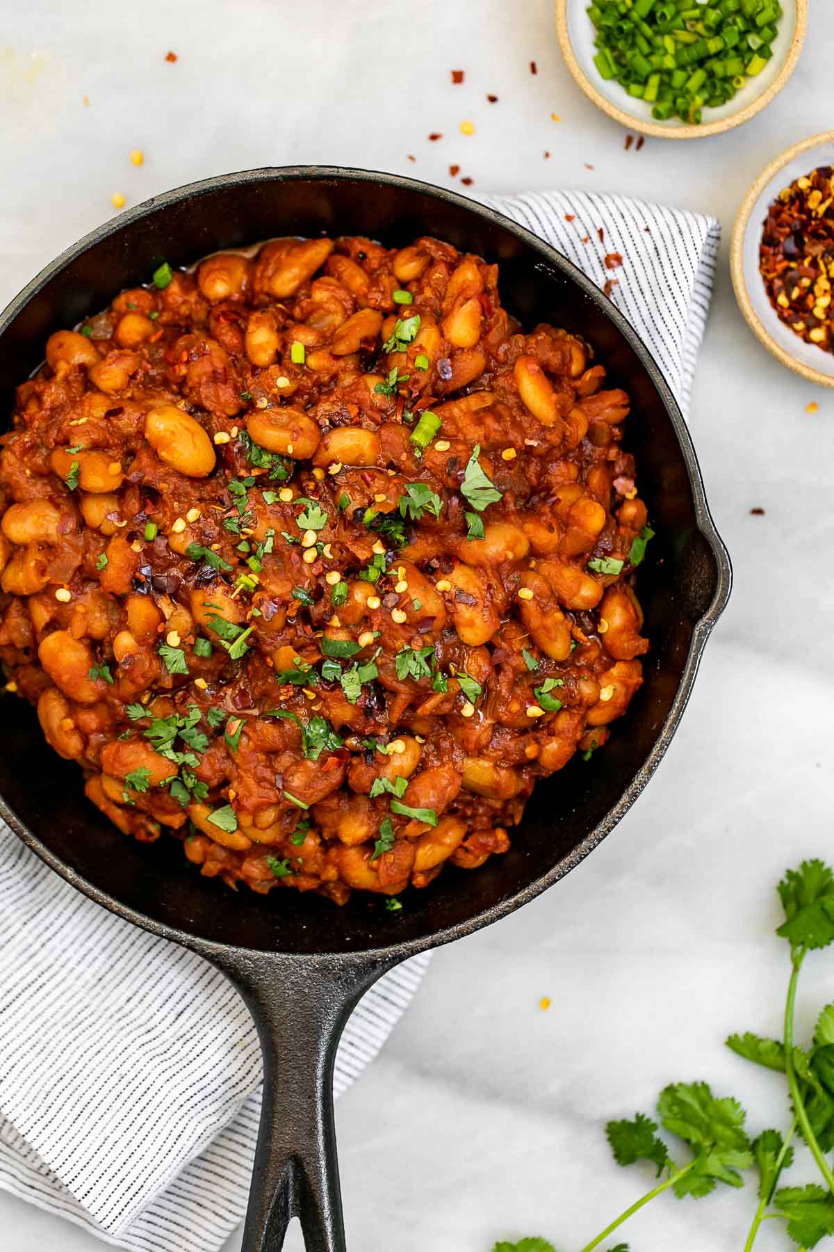 Vegan baked beans in a cast iron pan.