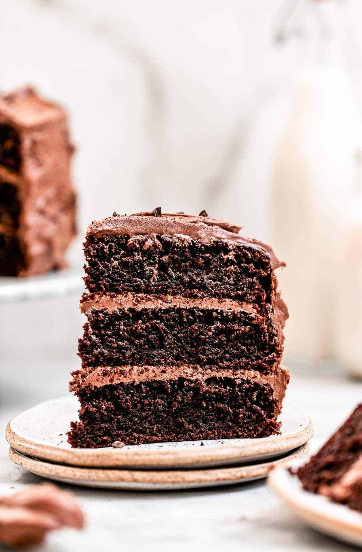 Three layer paleo chocolate cake on a plate.