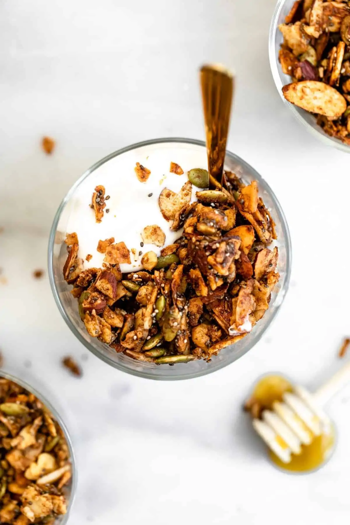 Paleo granola with honey on top in a small bowl. 