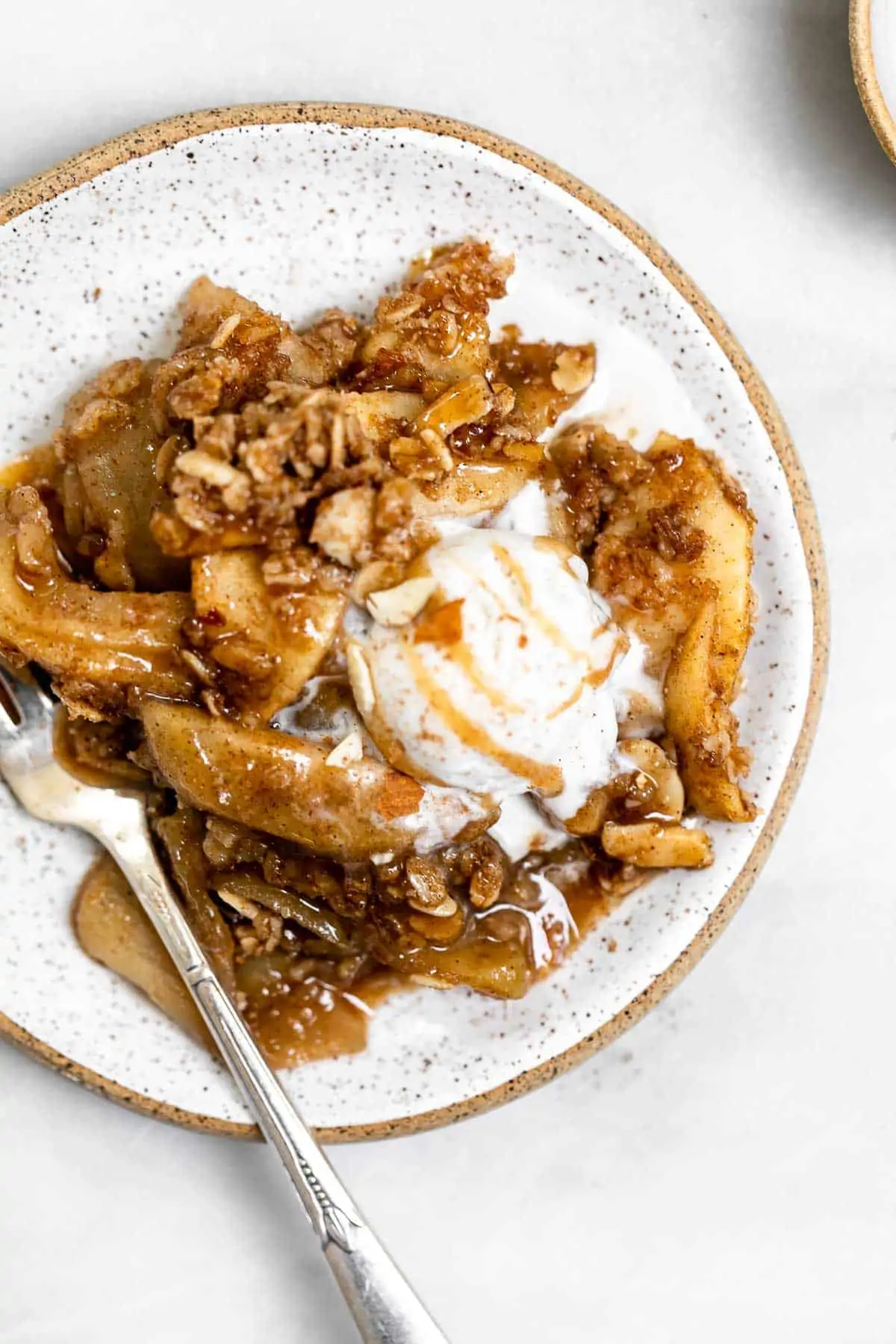 Apple crisp with oat crumble on a plate.