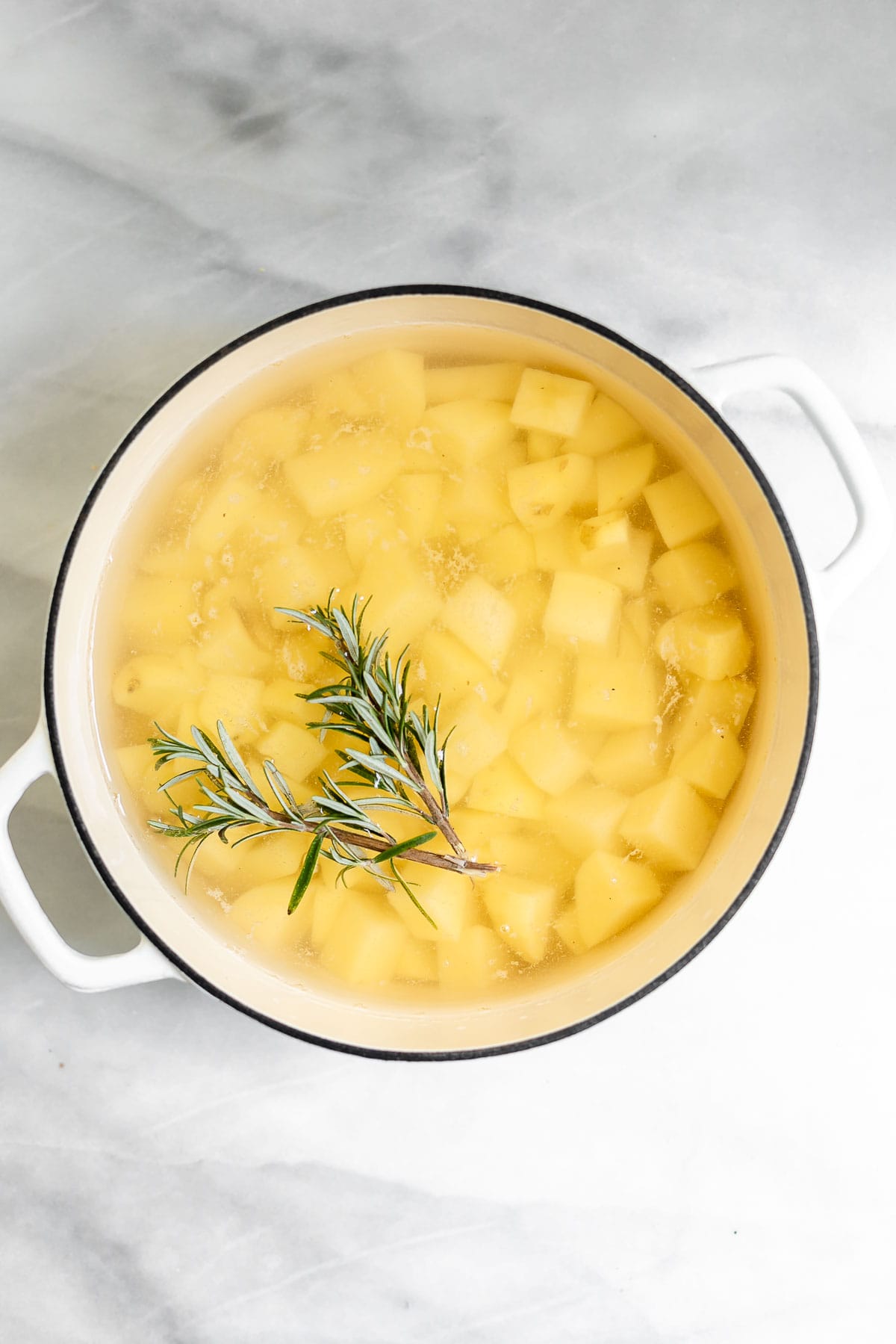 Potatoes in a pot with rosemary.