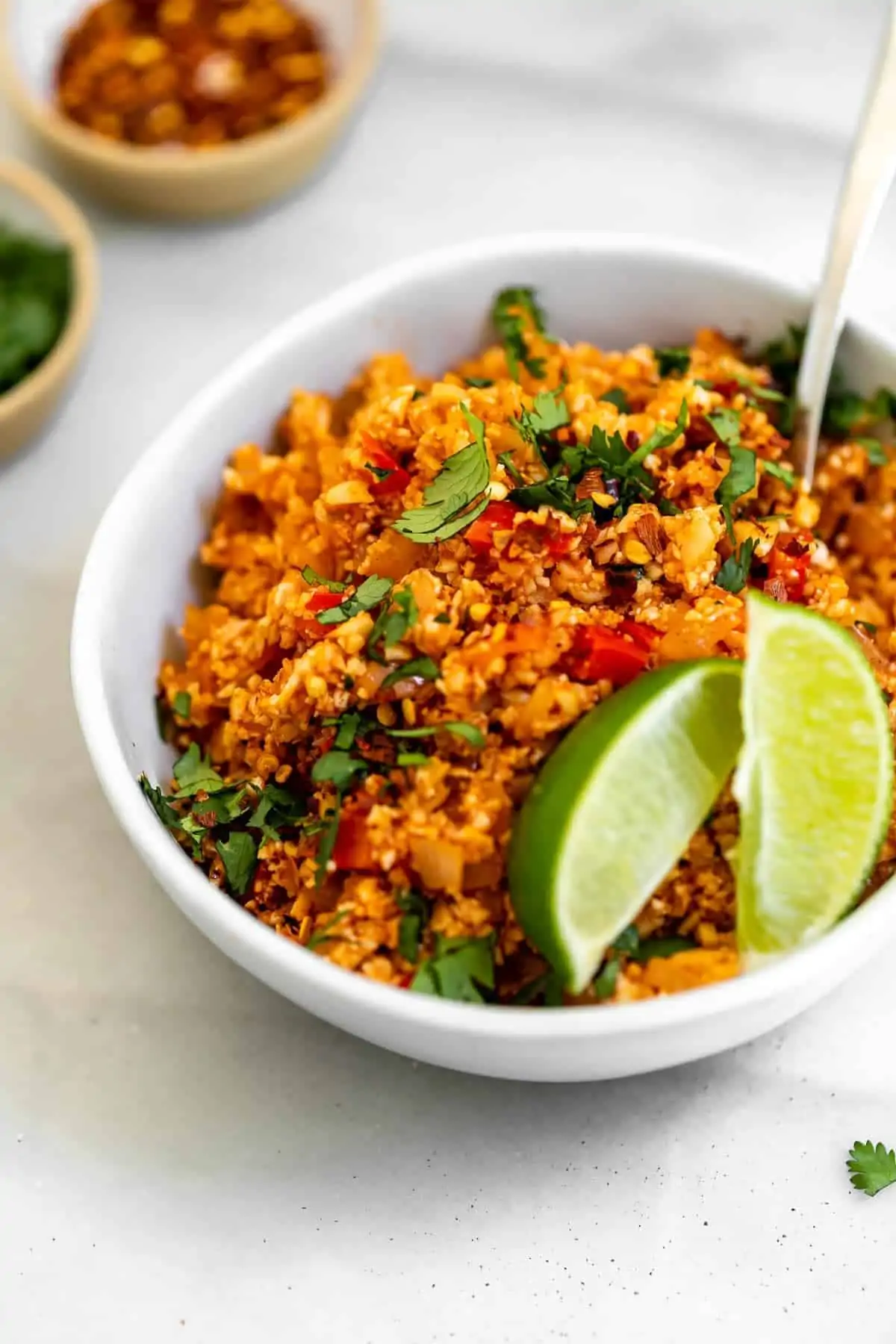 Vegan spanish mexican cauliflower rice in a bowl with cilantro.