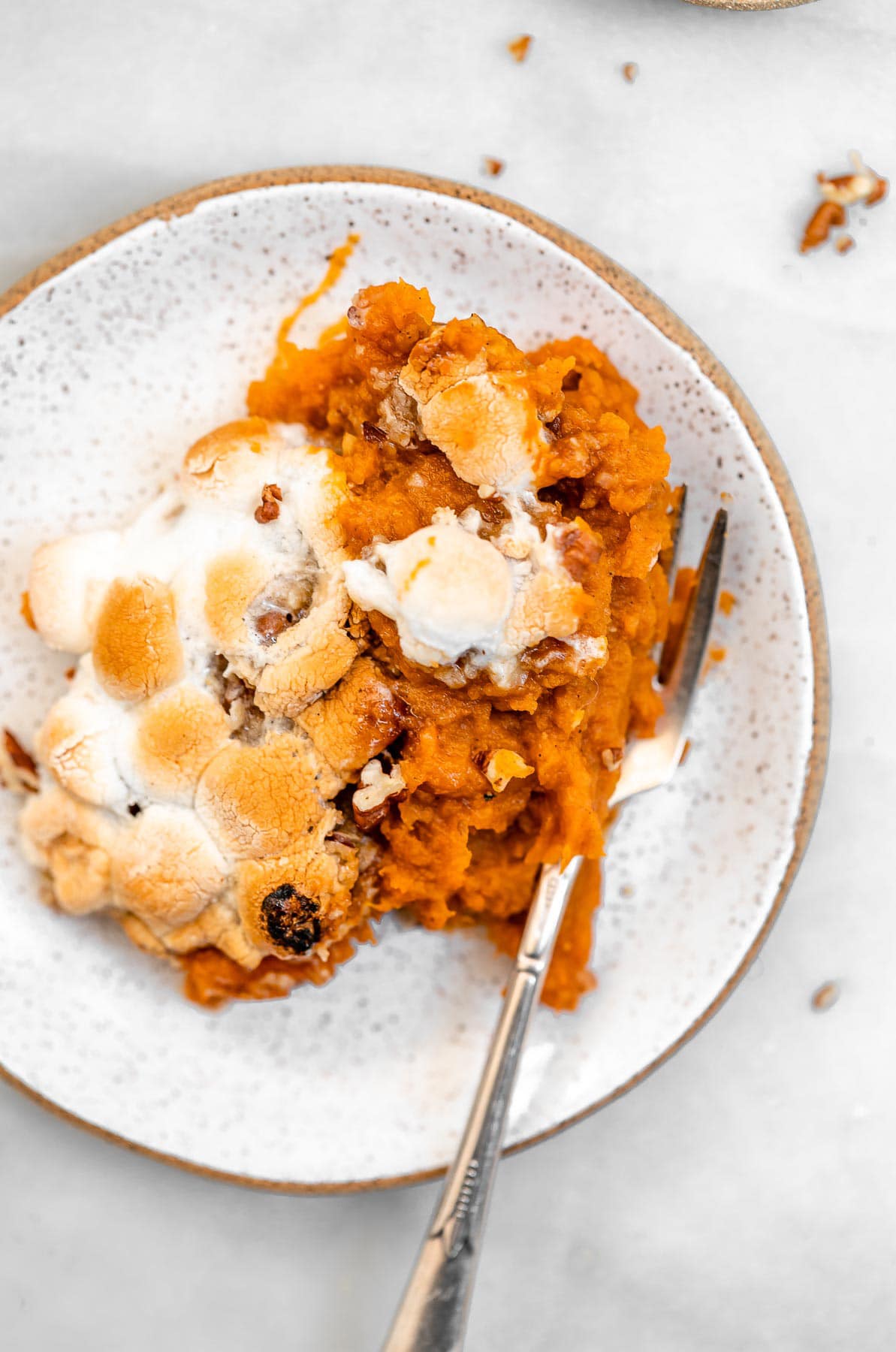 Vegan sweet potato casserole on a small plate with a fork.