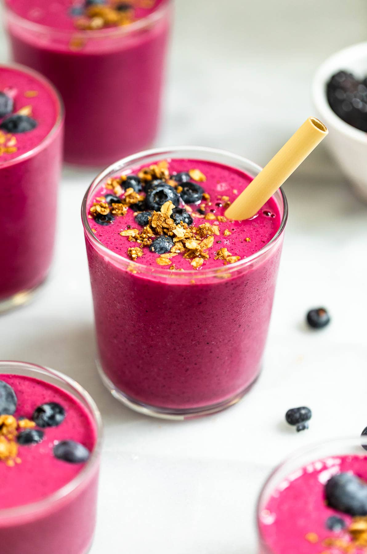 Vegan beet smoothie with granola and berries on top.