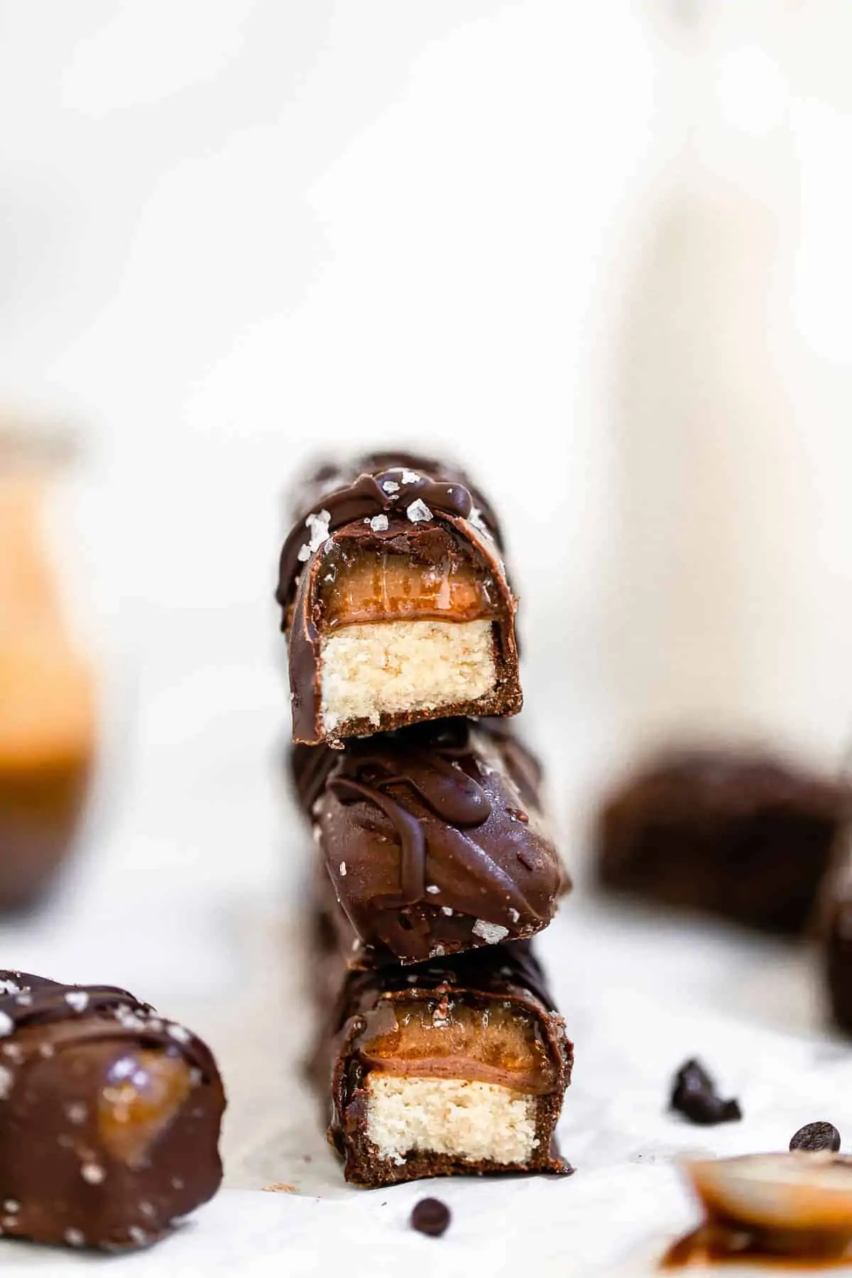 Homemade twix bars stacked on each other with bites taken out.