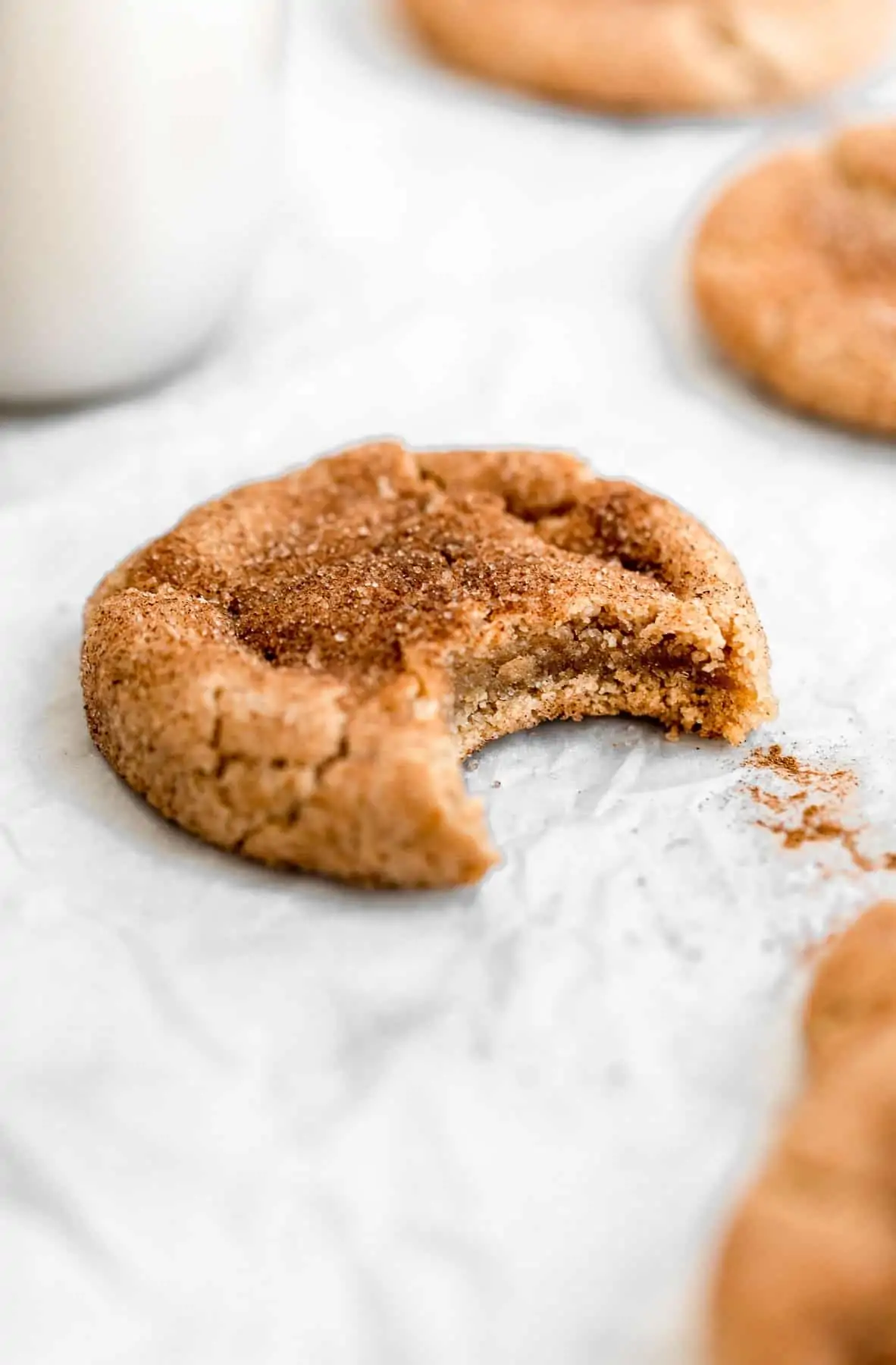 One vegan snickerdoodle with a bite taken out to show texture.