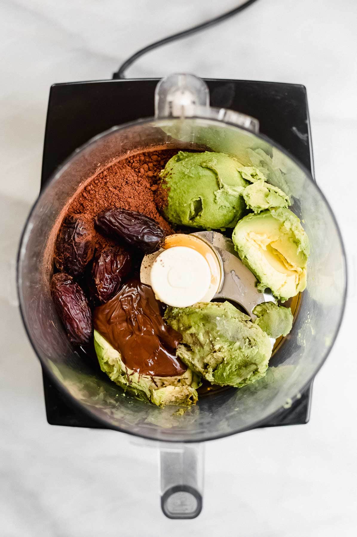 Ingredients for the avocado mousse in a food processor.