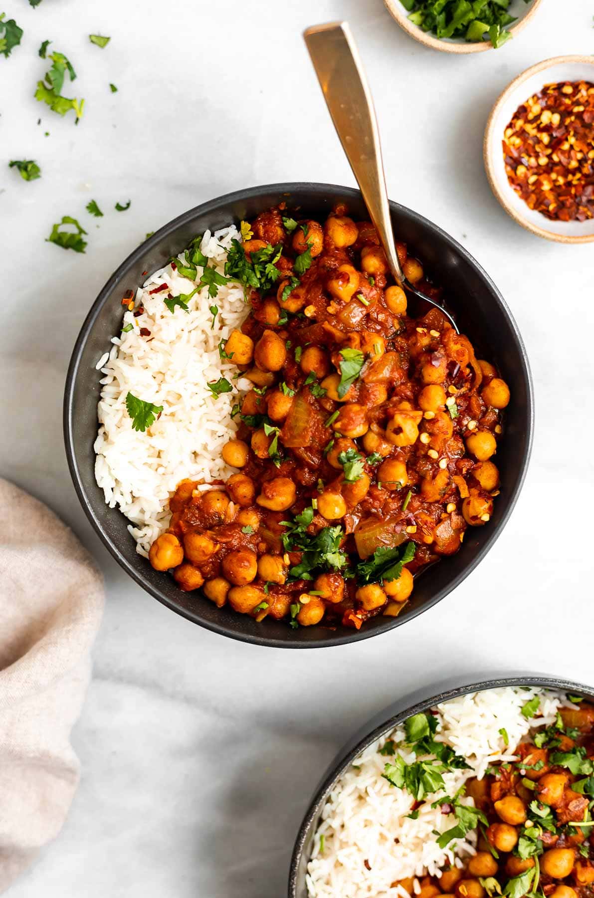 Vegan chana masala in two bowls with white rice.