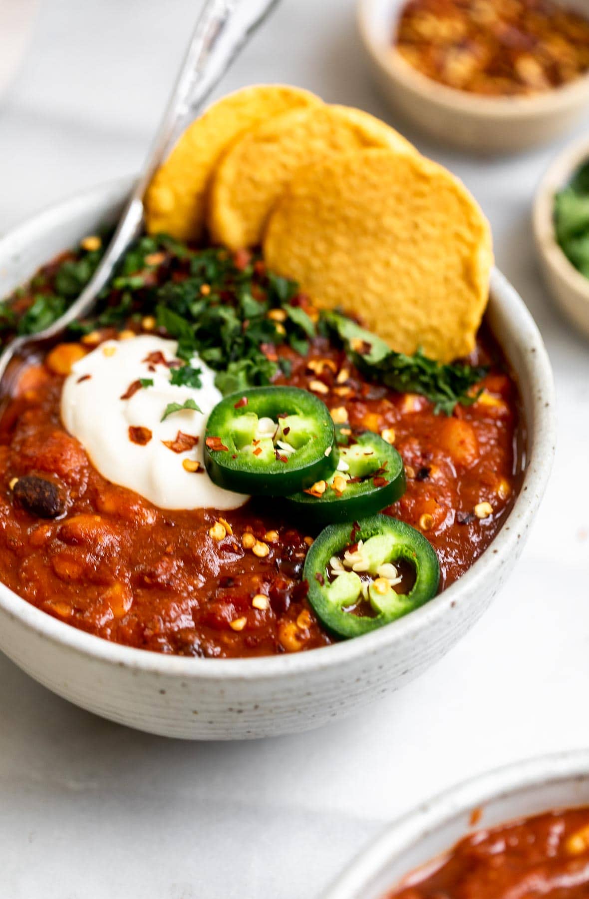 Vegan instant pot chili in a bowl with chips.