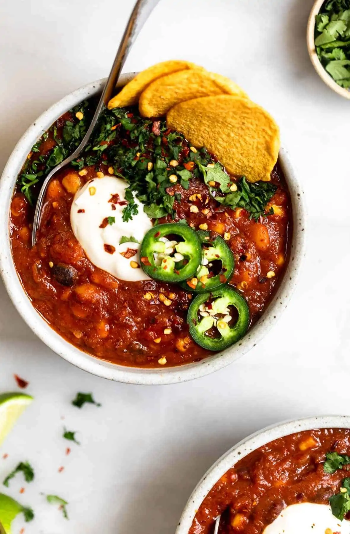 Instant pot vegan chili in a bowl with jalapeno on top.