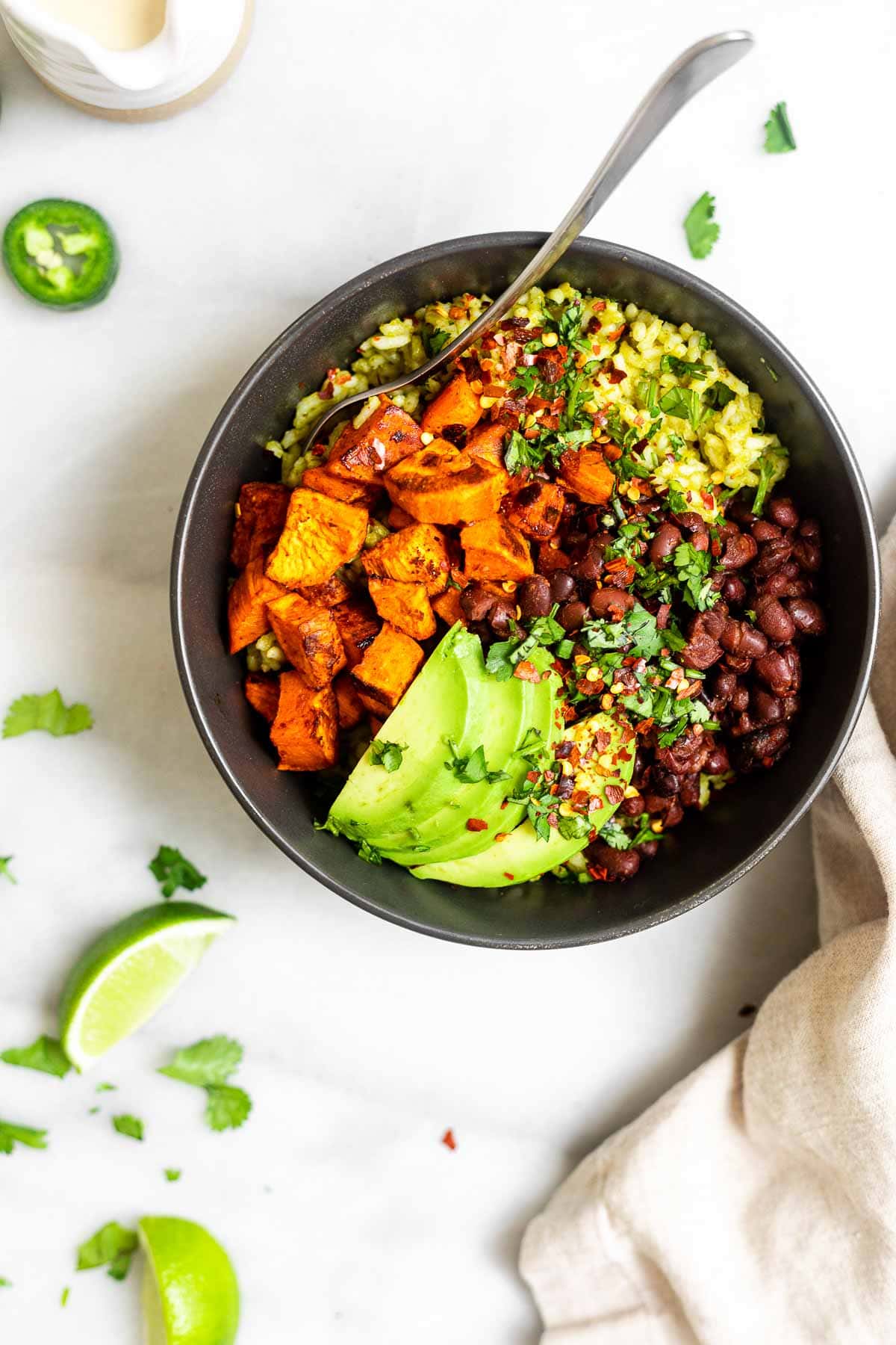 Nourish bowl with sweet potato in with a fork on the side.
