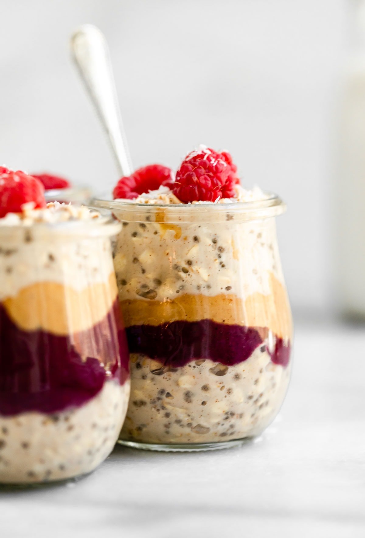 Peanut butter overnight oats with jam and raspberries.