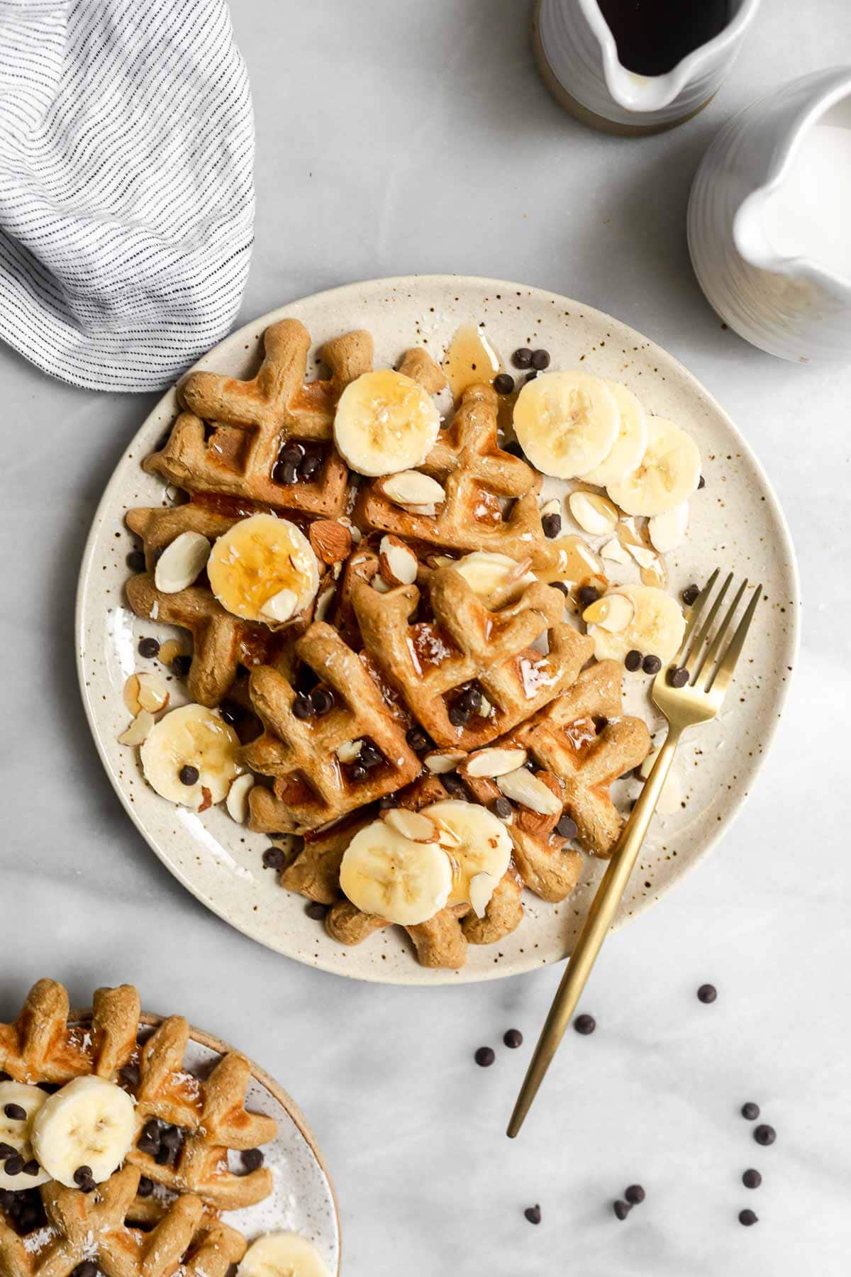 Peanut butter waffles with banana slices and chocolate chips. 