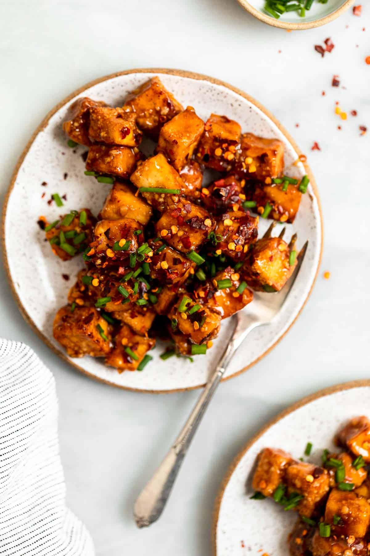 air fried tofu on a plate with a fork on the side
