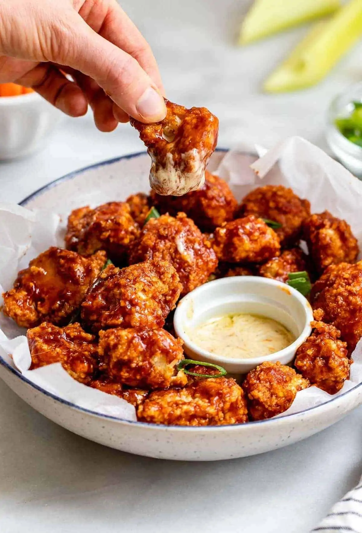 Dipping a bbq cauliflower wing into ranch.