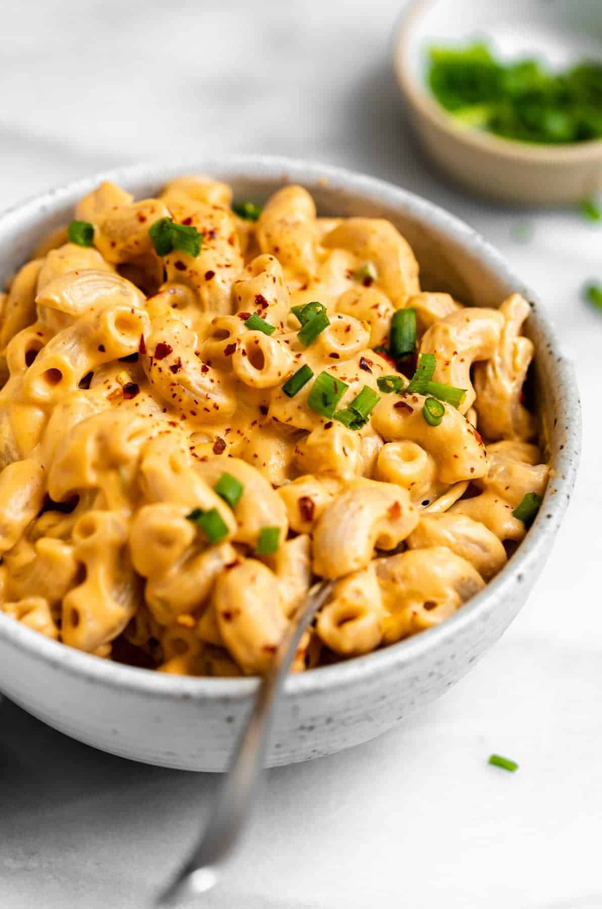 up close image of the buffalo mac and cheese in a bowl with elbow pasta