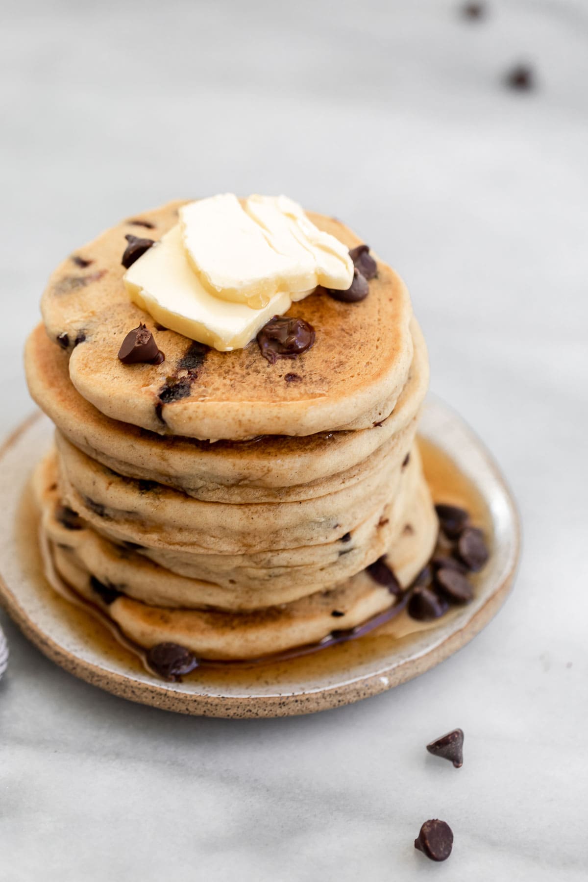 Tall stack of chocolate chip pancakes on a plate