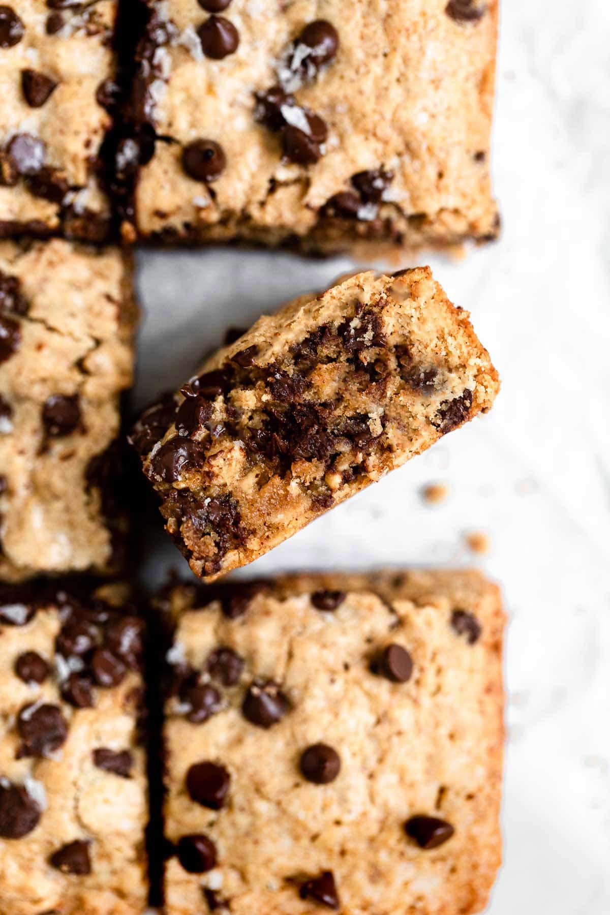 Up close of oatmeal chocolate chip bars with one bar turned on its side.