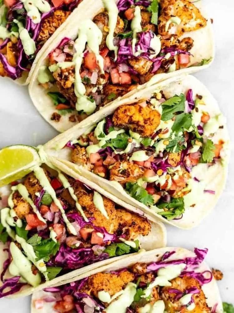 vegan cauliflower tacos with lime wedges