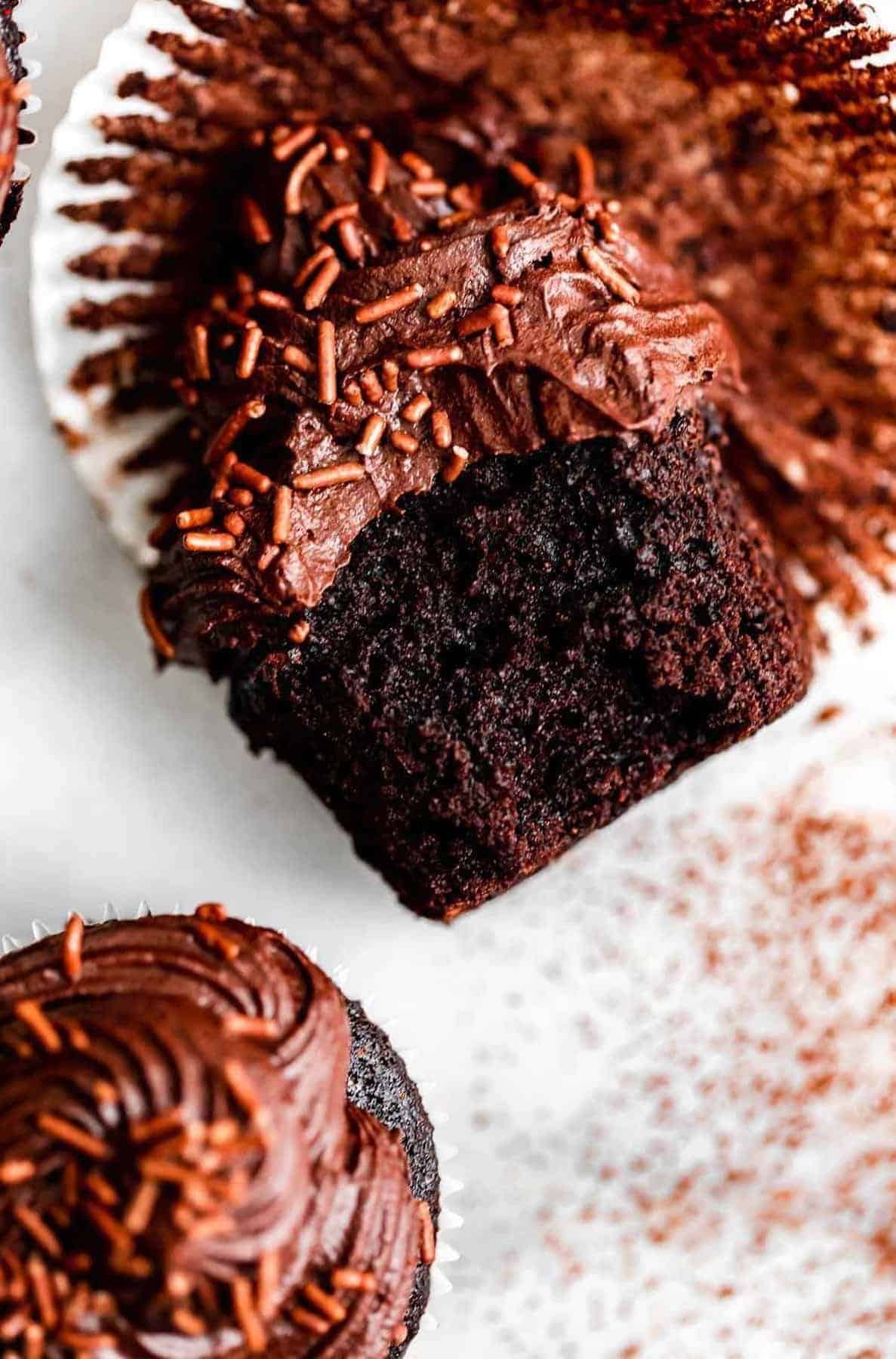 gluten free chocolate cupcake with a bite taken out to show fudgy texture