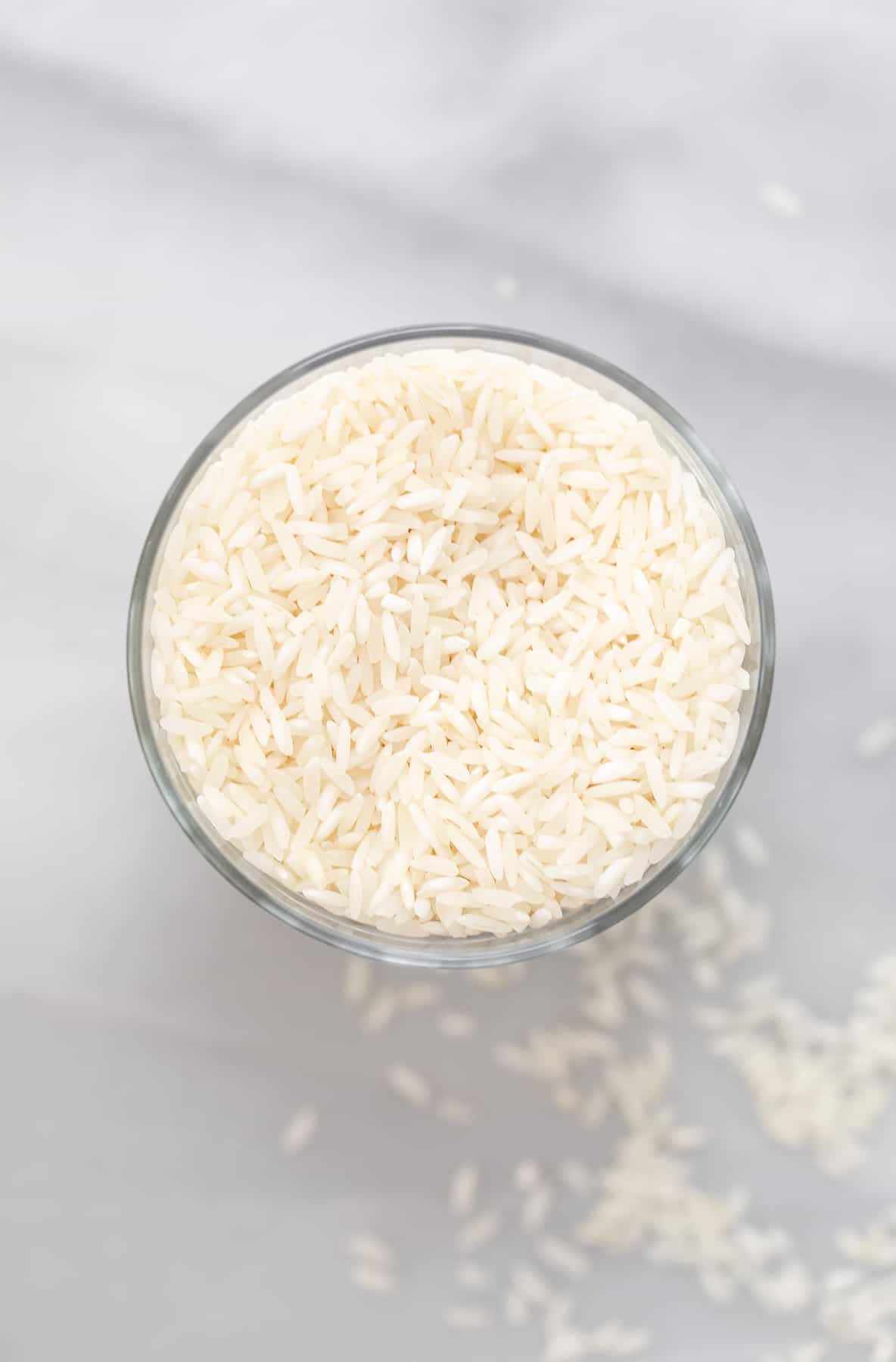 uncooked jasmine rice in a glass cup
