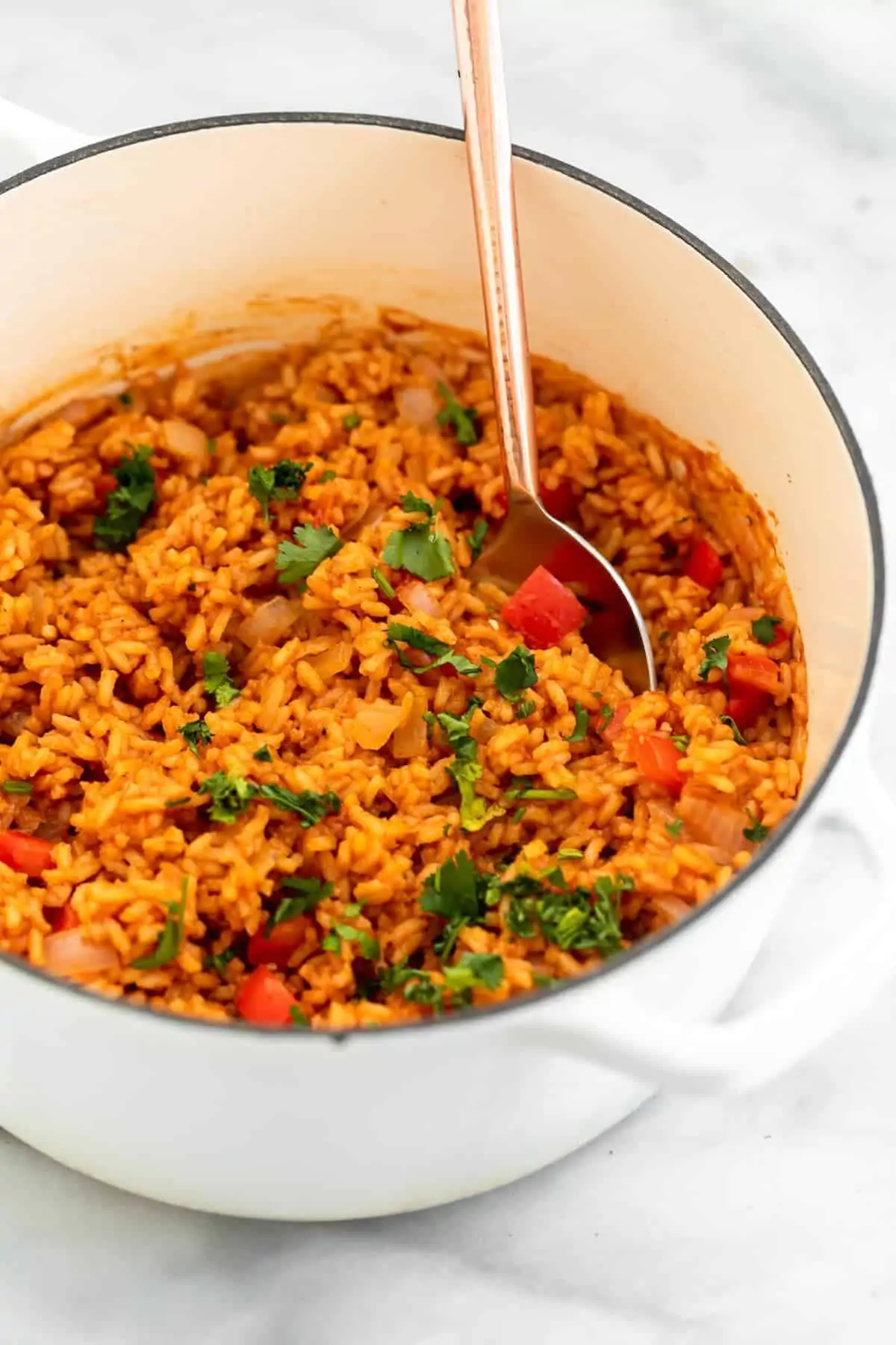 Cooked Spanish rice in a large white pot.