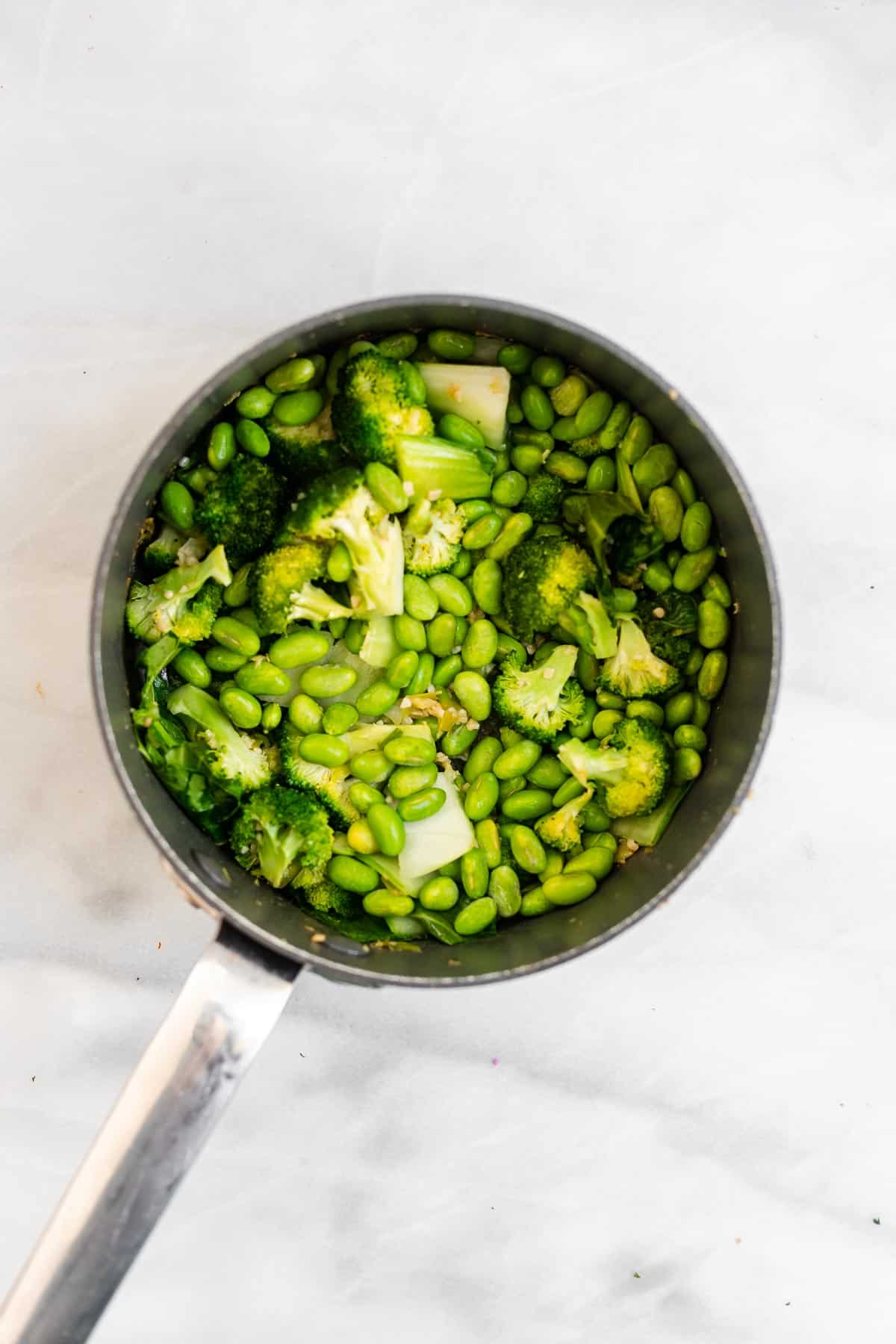 green vegetables in a pot with garlic