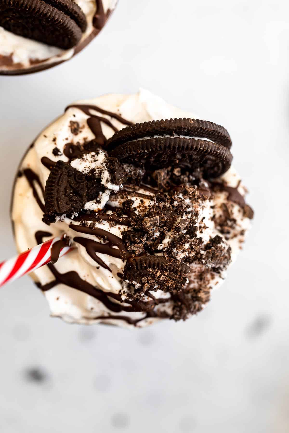 Overhead shot of the final milkshake with chocolate drizzled on top.