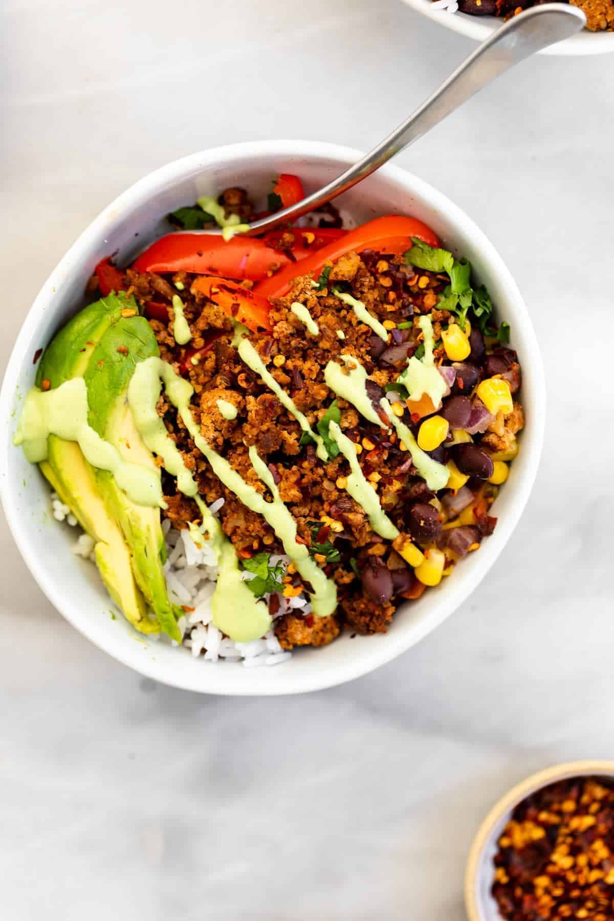 Taco bowl with walnut meat, veggies, beans, and rice.