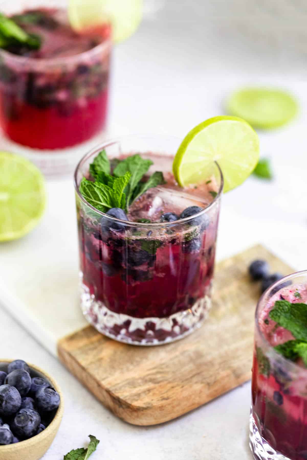 fresh blueberry mojito in a glass with mint leaves